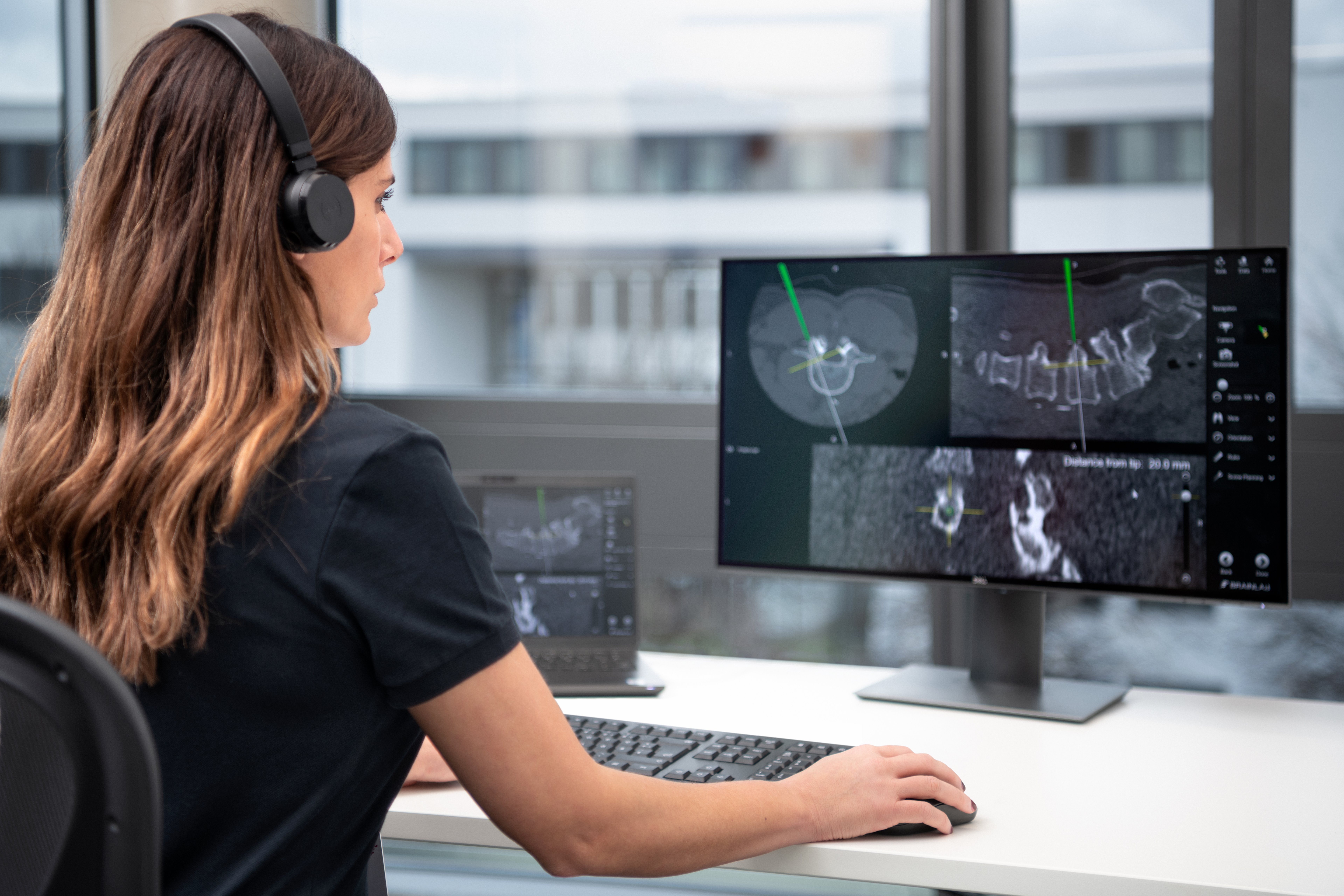 A Brainlab Service & Support employee is pictured supporting a customer via Connected Care.