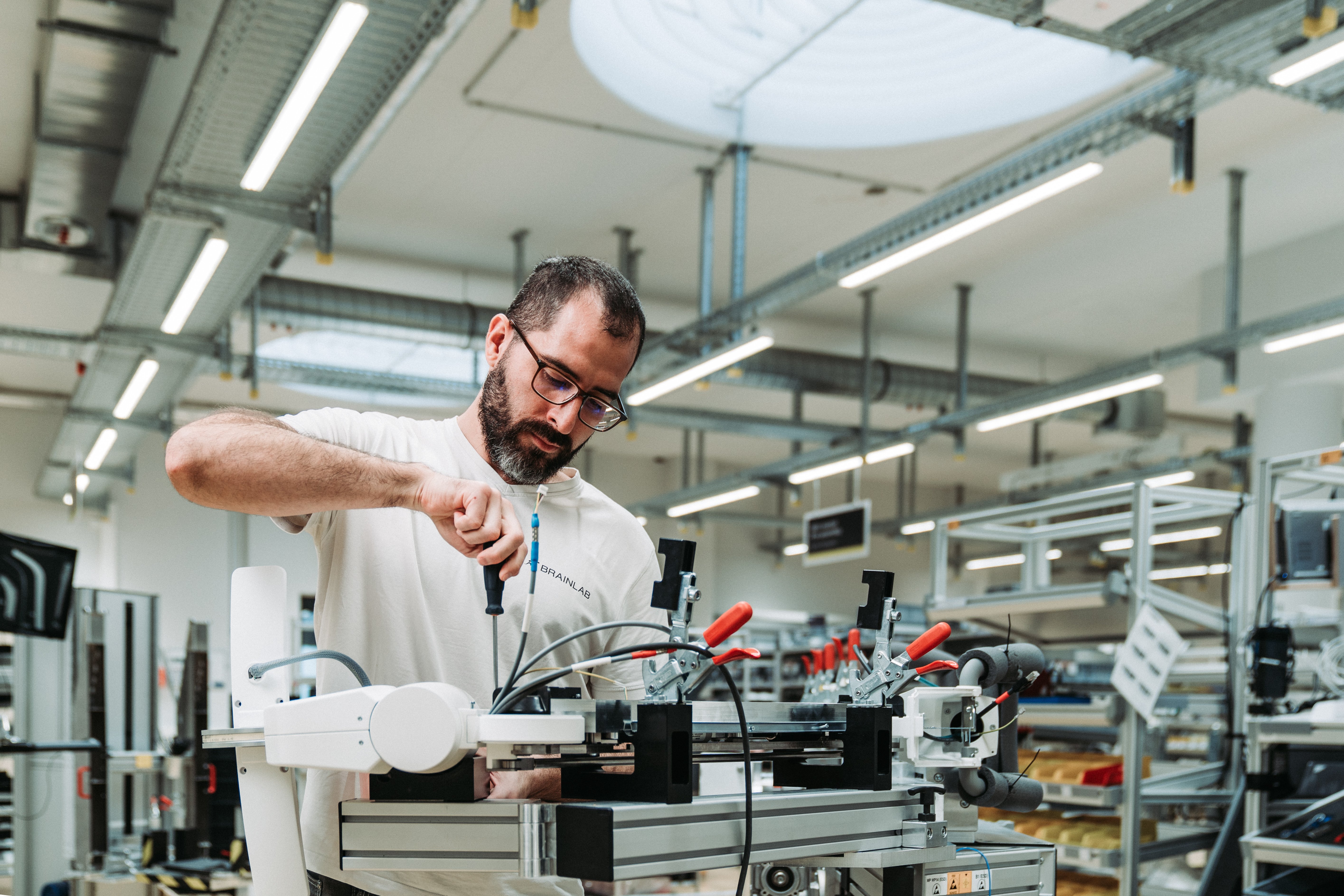 Technician assembling equipment in a manufacturing facility.